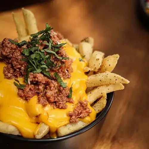 fries topped with melted queso cheese and beefy chili
