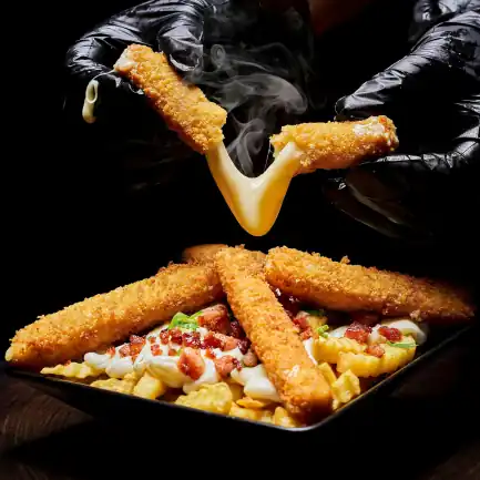 plate of loaded fries with mozza sticks, and a set of hands ripping another mozza stick in half